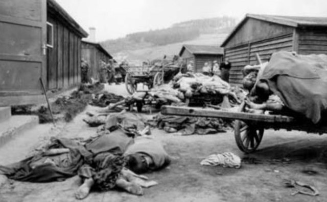640px-Prisoners'_Corpses_Beside_Cart_and_Barracks,_Mauthausen_Concentration_Camp,_May_8,_1945.jpg