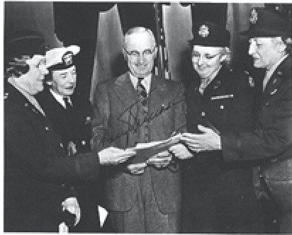 Truman after signing Army- Navy Nurses Act in 1947.jpg