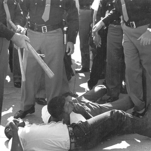 SNCC volunteers were beaten and arrested by sheriff’s deputies for attempting to bring water to people (many elderly) waiting in the hot sun for hours to register to vote in Selma, 1963