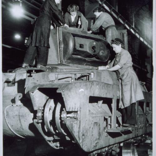 Women factory workers building tanks.