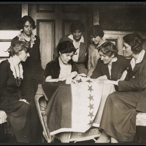 National Woman&#039;s Party activists watch Alice Paul sew a star onto the NWP Ratification Flag, representing another state&#039;s ratification of the 19th Amendment